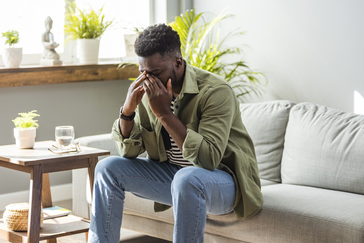 ea762375a531e45e07622aff21e5fdf0 black man in green shirt stressed
