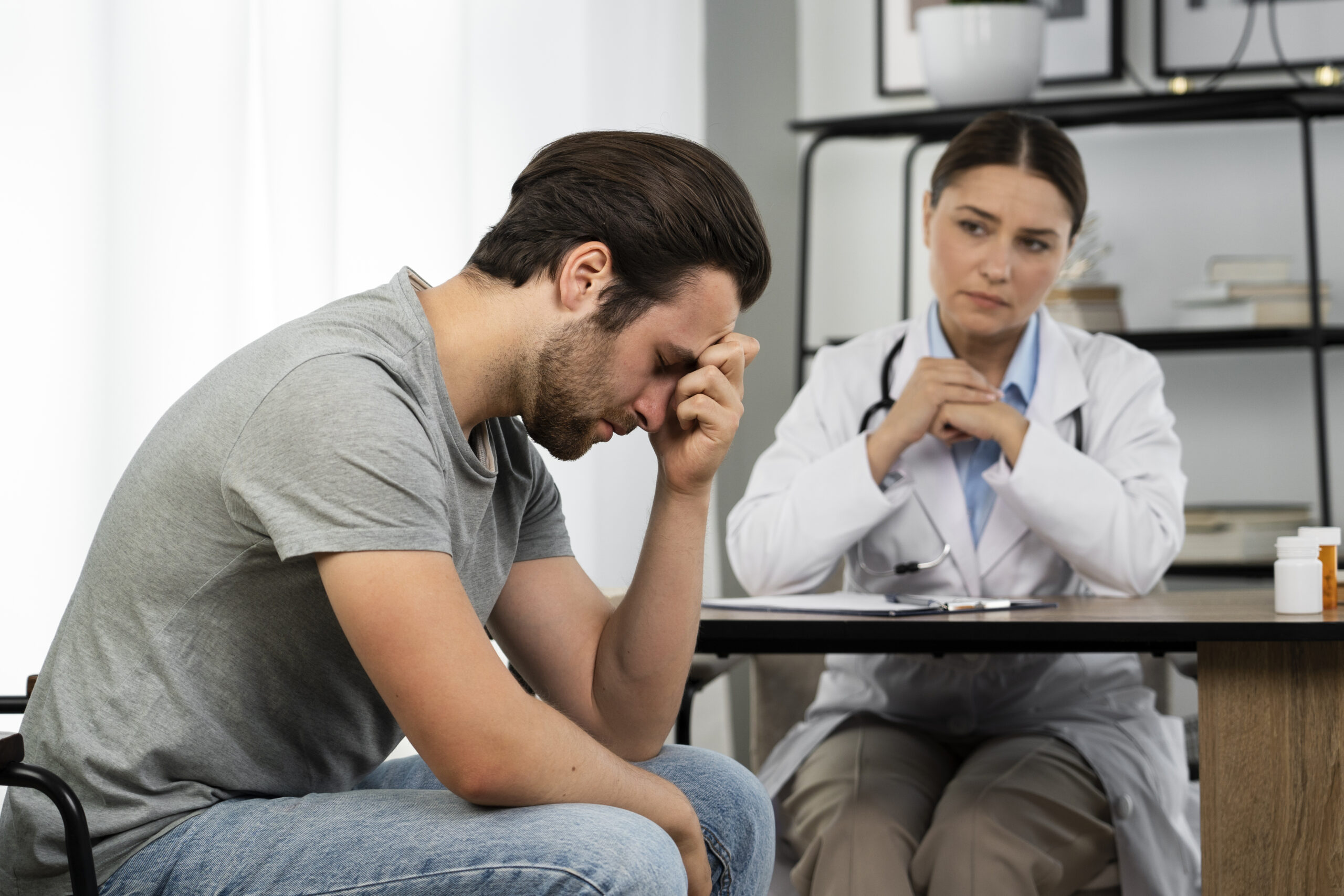 side view sad man doctor s appointment scaled